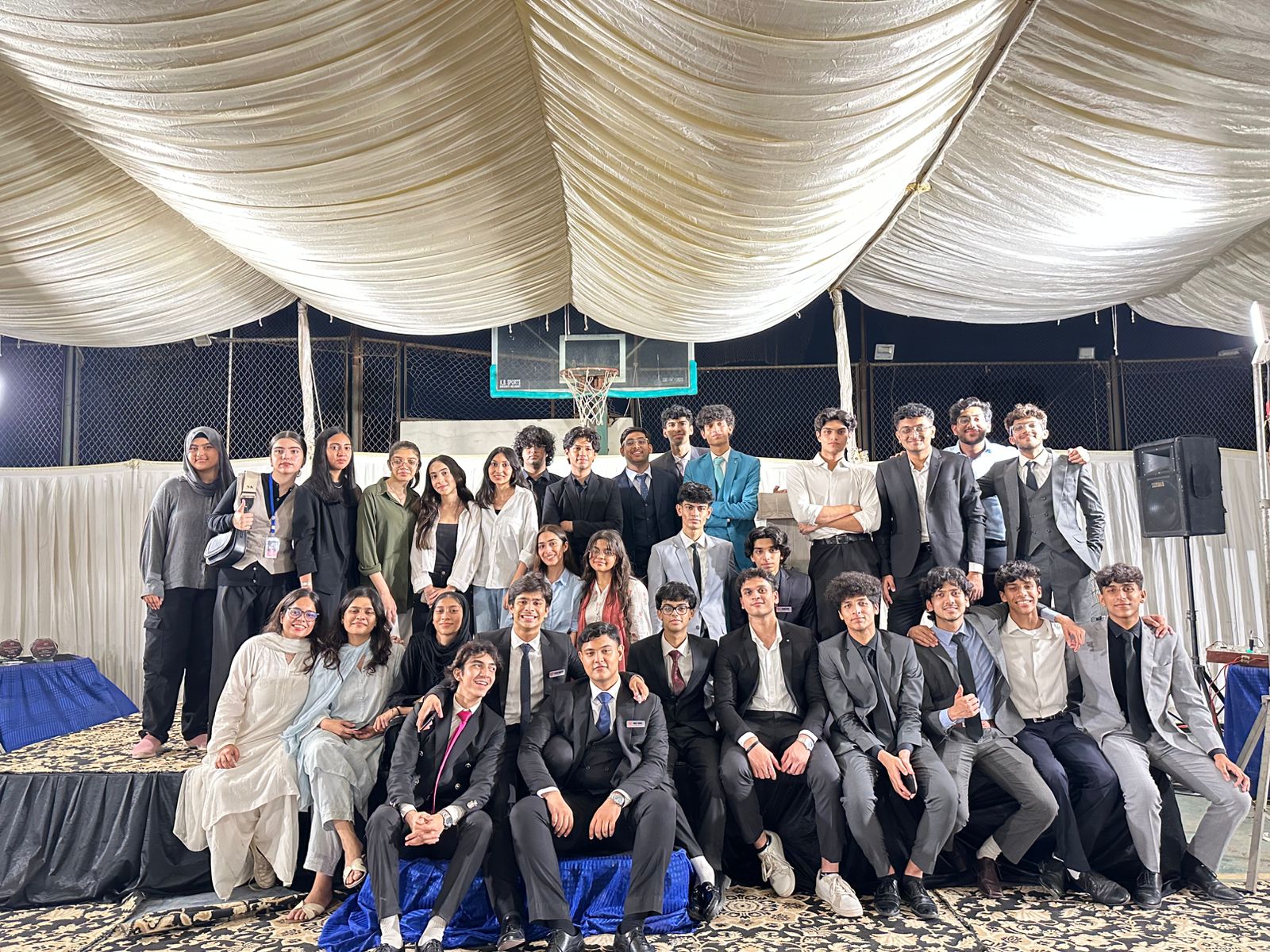 DCMUN delegates and organising team on stage at a previous edition